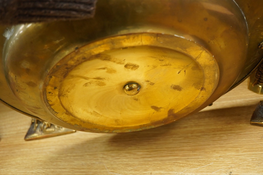 A group of copper and brassware to include candlesticks and an alms dish, 45cm in diameter